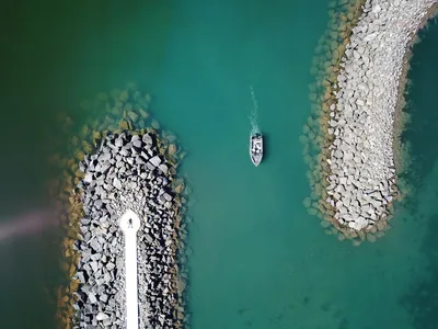 Drone shot of a small boat entering the rocky port of Duluth, Minnesota.