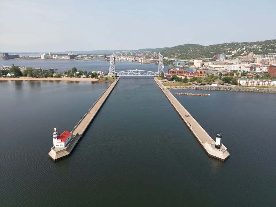 A stunning aerial shot of Duluth's iconic Aerial Lift Bridge and surrounding harbor on a clear day.