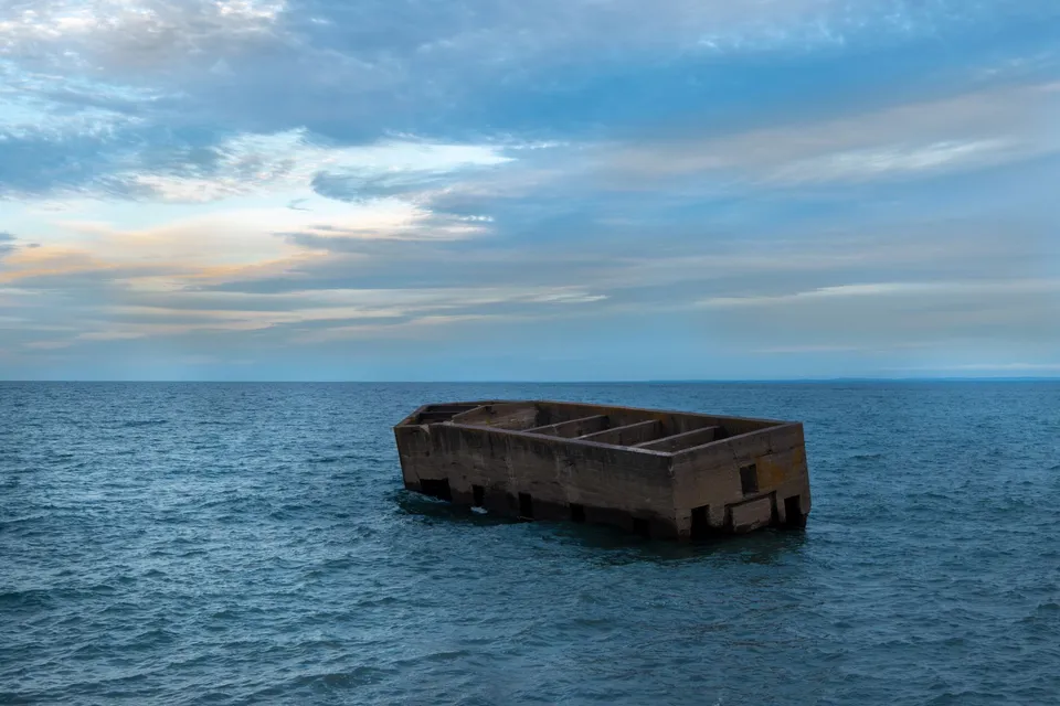 Abandoned concrete structure floating in Lake Superior, Duluth, Minnesota during daylight.
