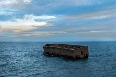 Abandoned concrete structure floating in Lake Superior, Duluth, Minnesota during daylight.